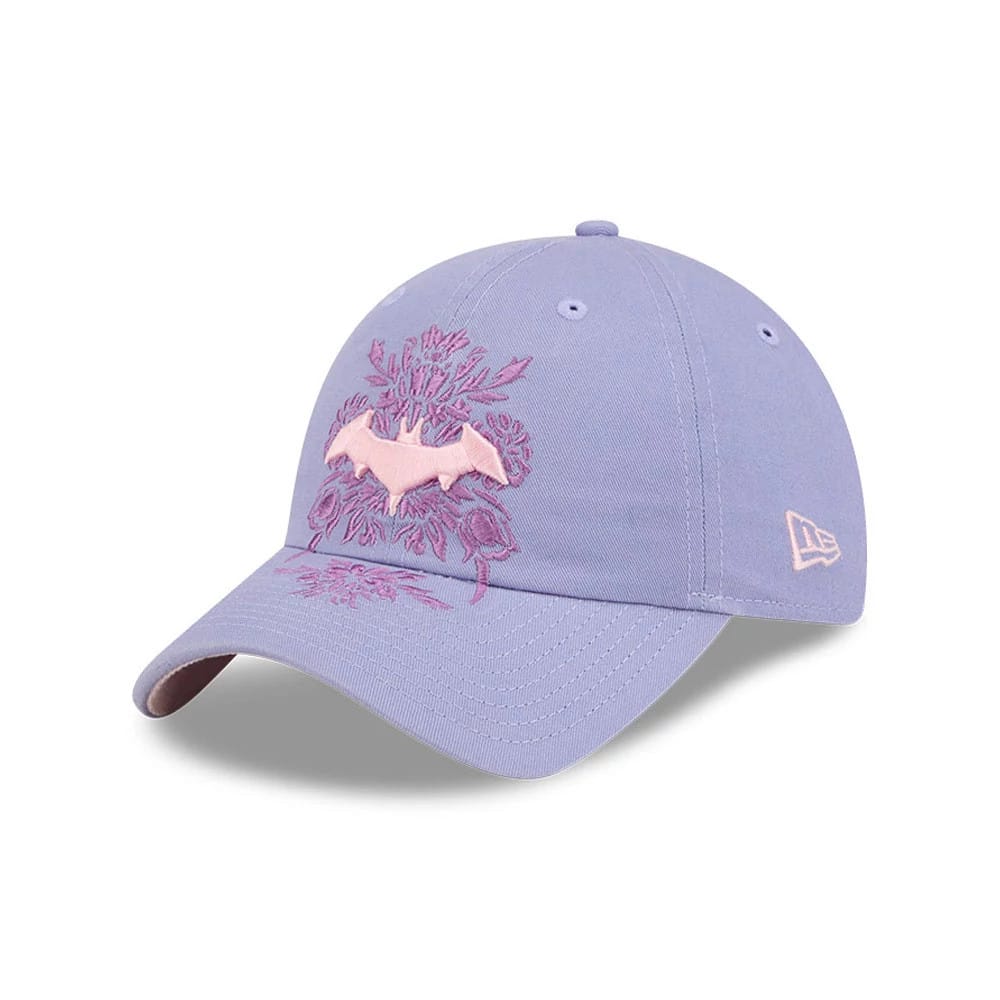 New Era Womens DC Batgirl Pastel Purple Casual Classic Adjustable Cap, front view showing the pink bat emblem and floral embroidery on the crown, with a curved pastel purple visor and the New Era flag logo embroidered in pink on the left side.