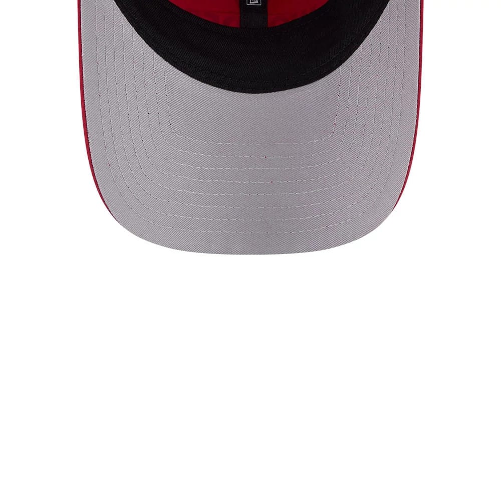 New Era Womens DC Wonder Woman Dark Red Open Back Cap, inside view showing the light grey undervisor, black sweatband with a small size tag at the centre, and grey stitching lines around the visor edge, highlighting durability and design.