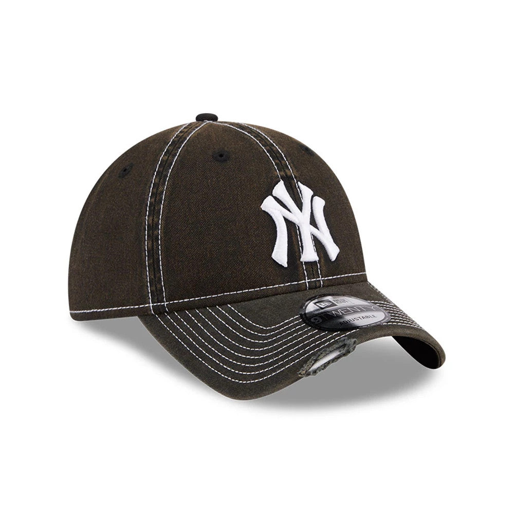 New York Yankees MLB Stencil Distressed Black New Era 9TWENTY Adjustable Cap, three-quarter view showing the raised white Yankees logo on the front panel, distressed black curved visor with a 9TWENTY size sticker, and white stitching details.