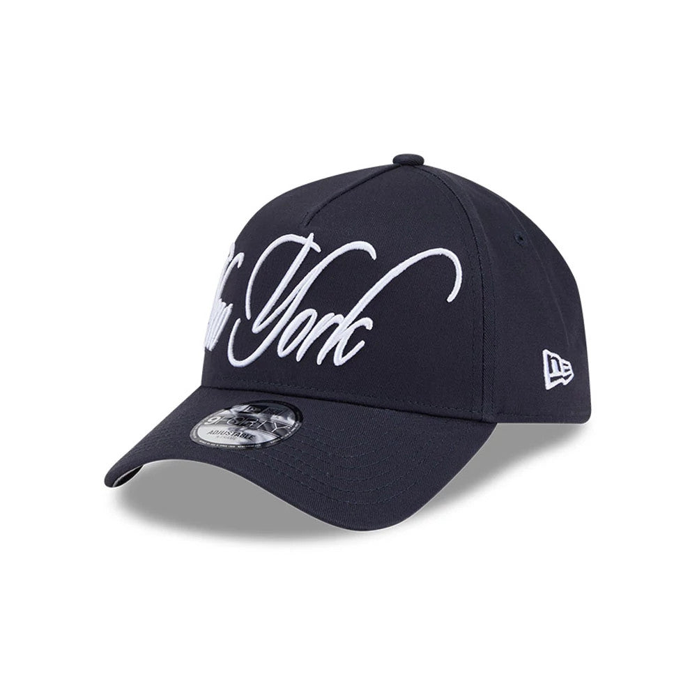 New York Yankees MLB Calligraphy Navy New Era 9FORTY A-Frame Adjustable Cap, three-quarter view showing the white embroidered New York calligraphy on the front panel, navy curved visor with a 9FORTY size sticker.
