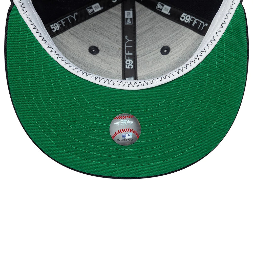 New York Highlanders MLB Cooperstown Navy New Era 59FIFTY Fitted Cap, inside view showing the green undervisor with a baseball design sticker, grey sweatband edges and black 59FIFTY branded taping crossing the grey fabric panels.