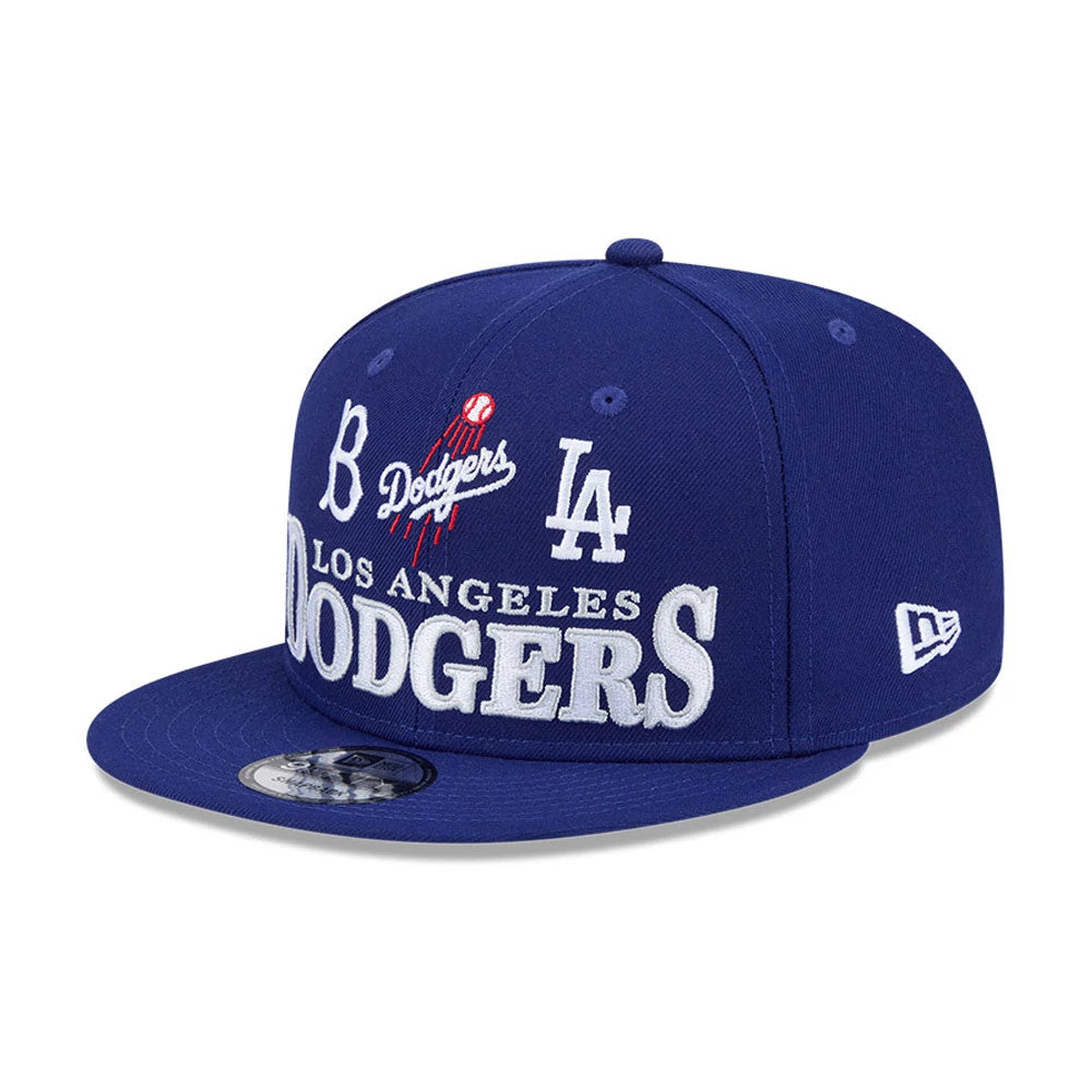 LA Dodgers MLB Cooperstown Throwback Blue New Era 9FIFTY Snapback Adjustable Cap, front view showing the large white embroidered Dodgers lettering across the front panels, red and white Dodgers logo above, flat blue visor with 9FIFTY size sticker.