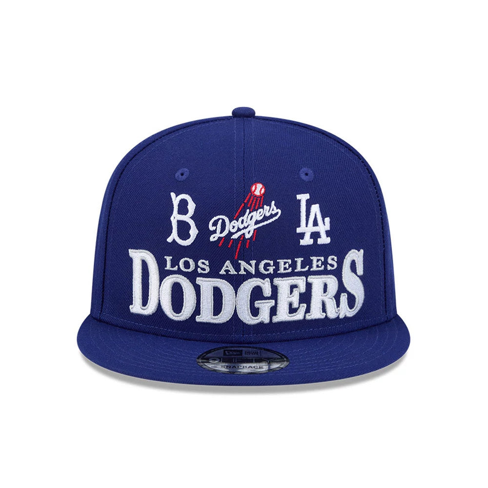 LA Dodgers MLB Cooperstown Throwback Blue New Era 9FIFTY Snapback Adjustable Cap, front view showing raised white embroidered Los Angeles Dodgers lettering, classic team logos on the blue structured crown, and a 9FIFTY size sticker on the flat visor.