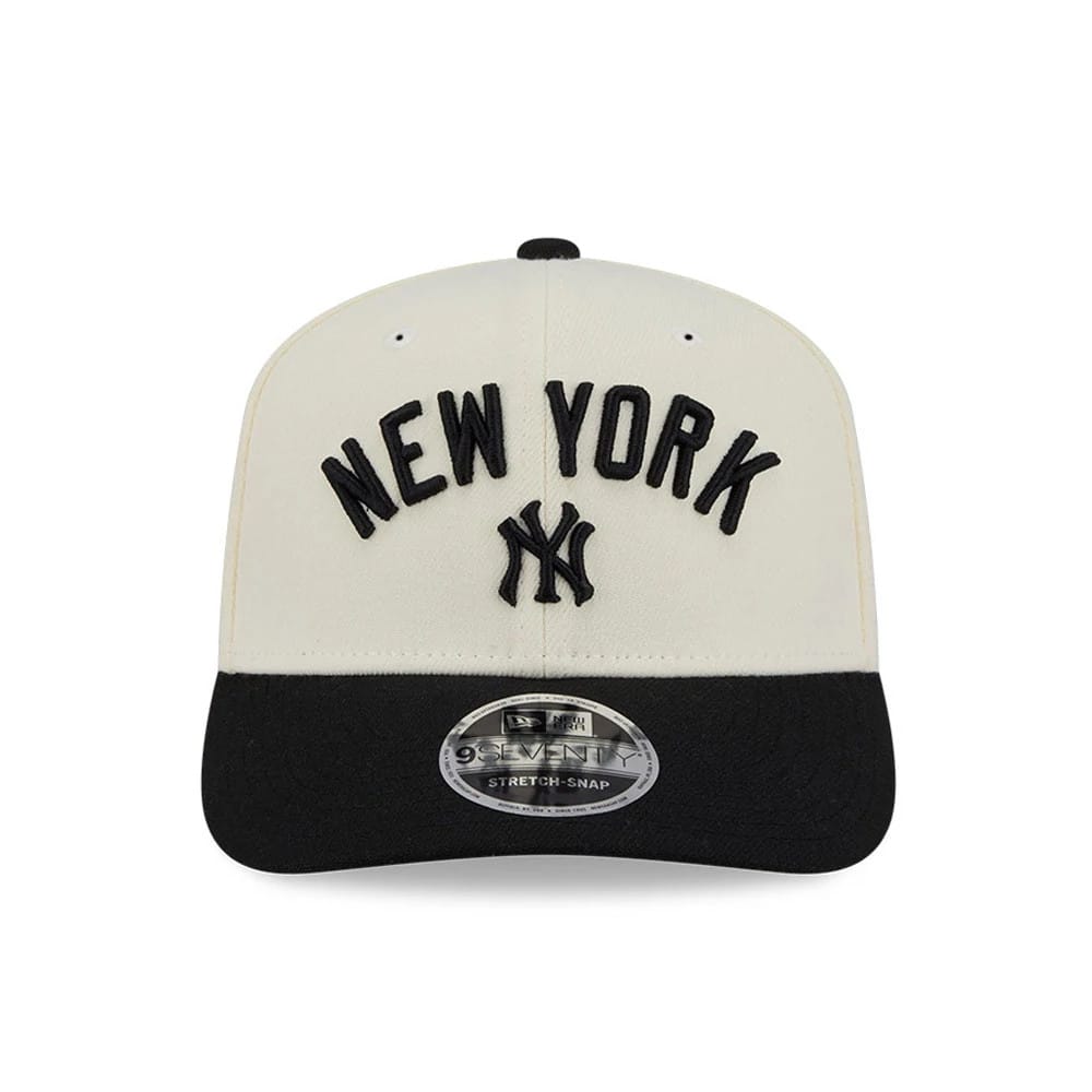 Yankees MLB 2 Tone Cream & Black New Era 9SEVENTY Stretch Snap Adjustable Cap, front view showing raised black New York lettering and NY logo embroidered on the cream front panels, with a black curved visor and 9SEVENTY size sticker.