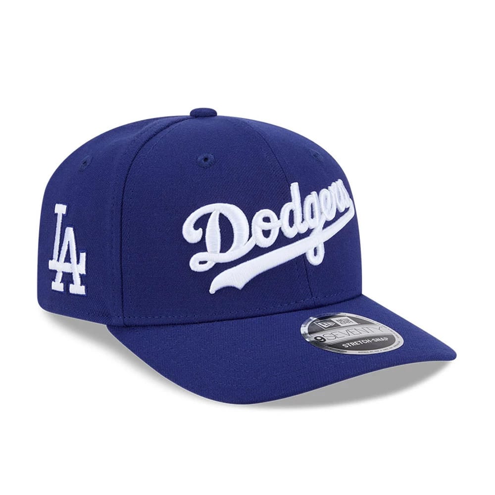 LA Dodgers MLB Dark Blue New Era 9SEVENTY Stretch Snap Adjustable Cap, three-quarter view showing the raised white Dodgers script logo on the front panel, white embroidered LA logo on the left side, and a silver 9SEVENTY size sticker on the visor.