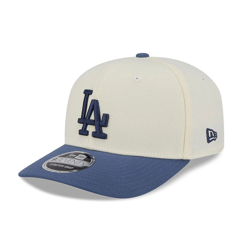 Dodgers MLB Slate Stone Cream & Dark Blue New Era 9SEVENTY Stretch Snap Adjustable Cap, three-quarter view showing the navy embroidered LA logo on the cream front panel, dark blue visor with a 9SEVENTY size sticker.