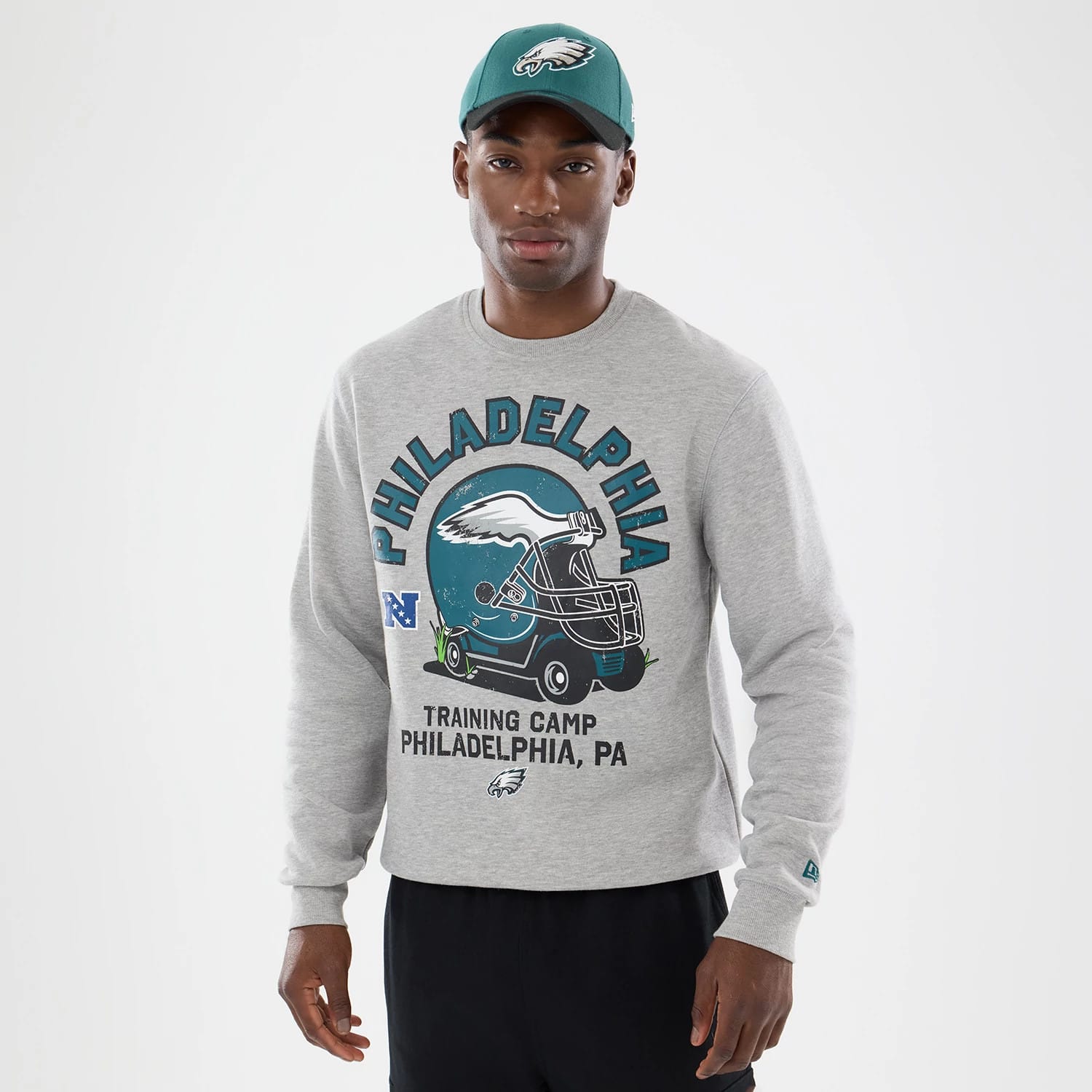 The model is wearing this NFL Training 2026 Philadelphia Eagles Crew Neck Sweater in grey. 1
