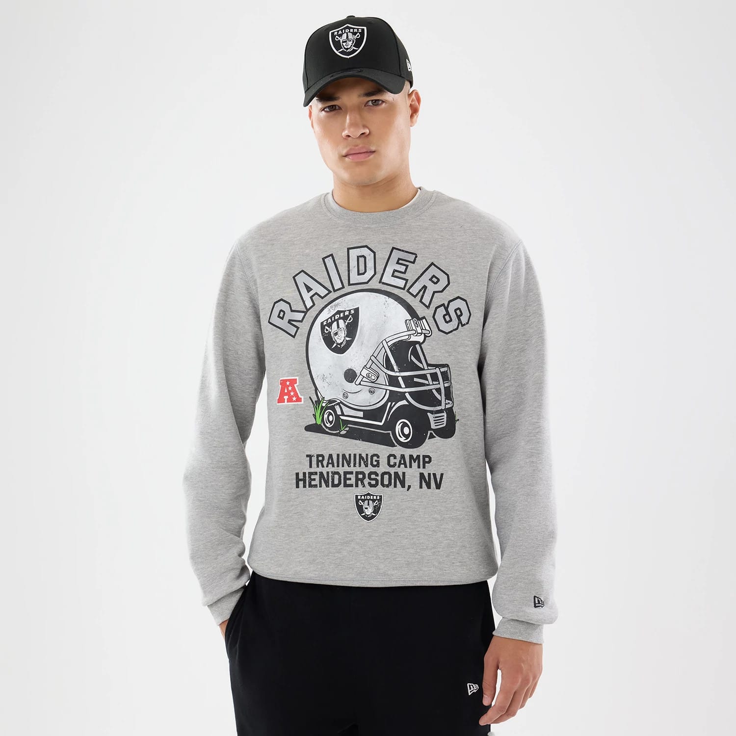 The model is wearing this NFL Training 2026 Las Vegas Raiders Crew Neck Sweater in grey. 1