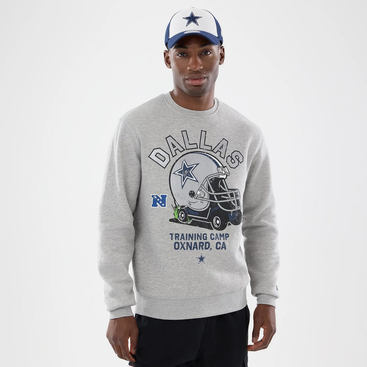 The model is wearing this NFL Training 2026 Dallas Cowboys Crew Neck Sweater in grey. 1