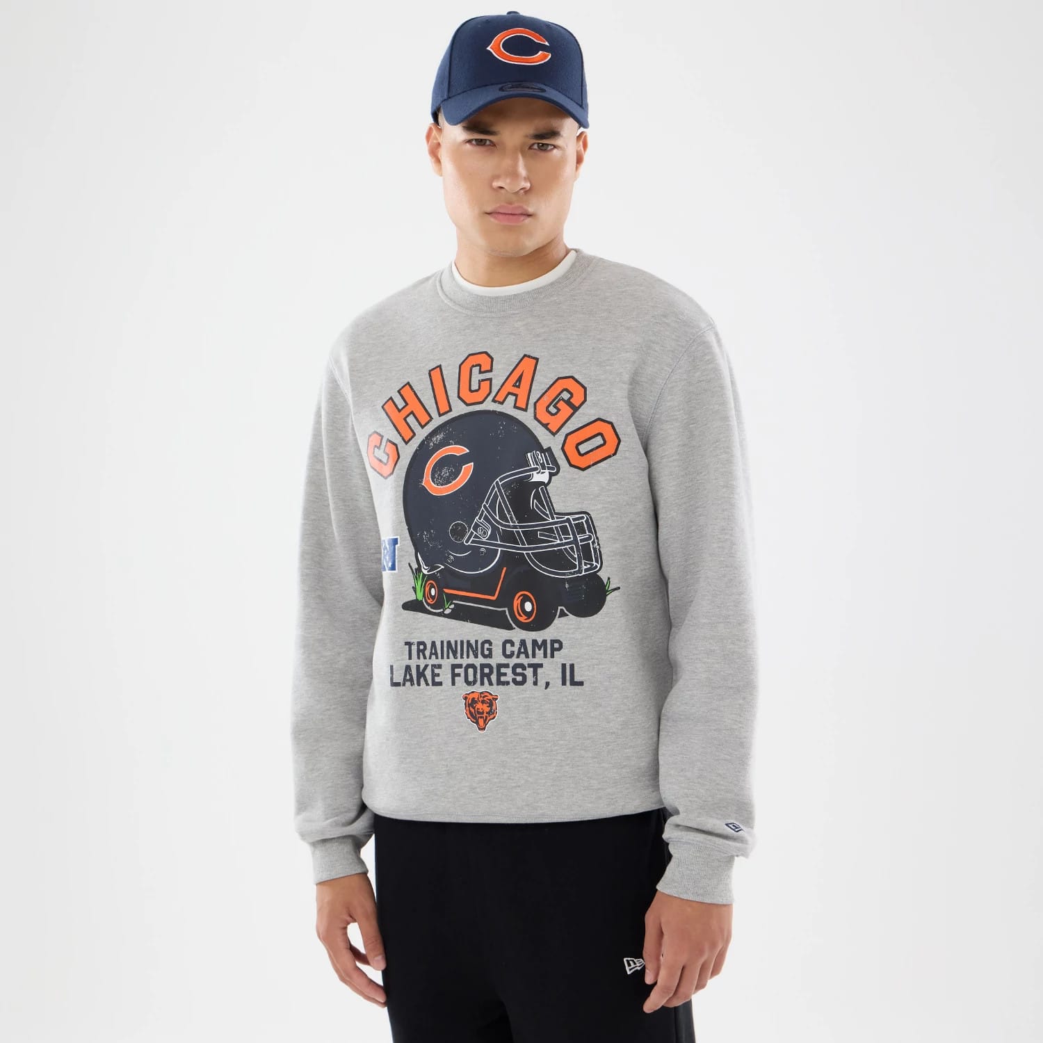 The model is wearing this NFL Training 2026 Chicago Bears Crew Neck Sweater in grey. 1