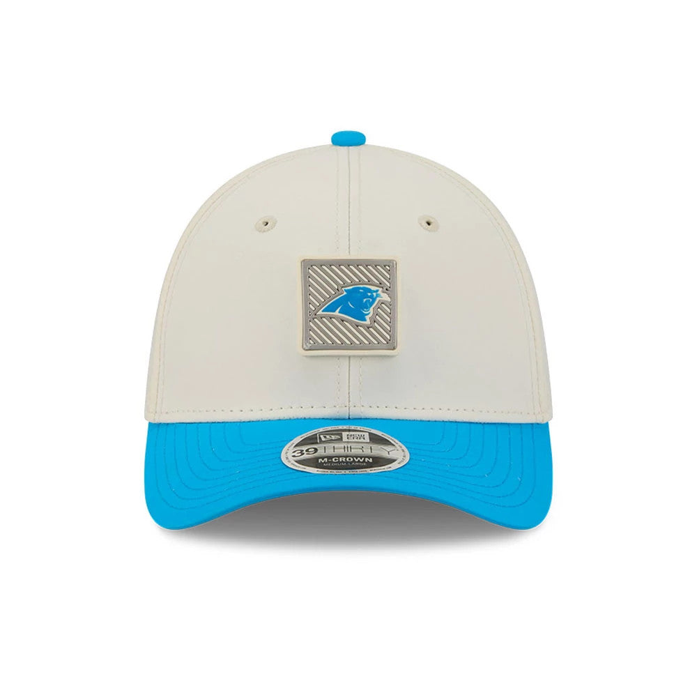Carolina Panthers NFL Training 2026 White New Era 39THIRTY M-Crown Stretch Fit Cap, front view showing a blue Panthers logo set in a grey badge on the white front panel, with a cyan blue visor and a 39THIRTY size sticker on the curved visor.
