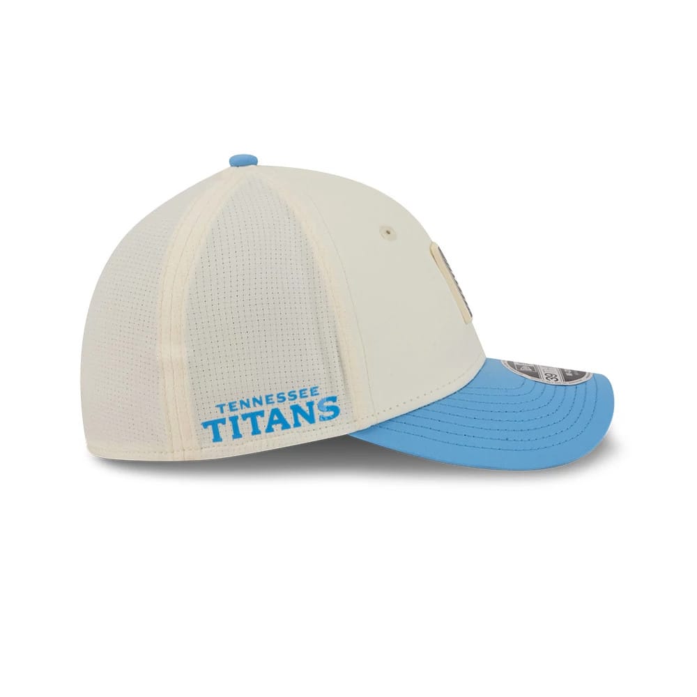 Tennessee Titans NFL Training 2026 White New Era 39THIRTY M-Crown Stretch Fit Cap, side view showing the blue embroidered Tennessee Titans text on the rear panel, structured white crown with perforations, and contrasting light blue curved visor.