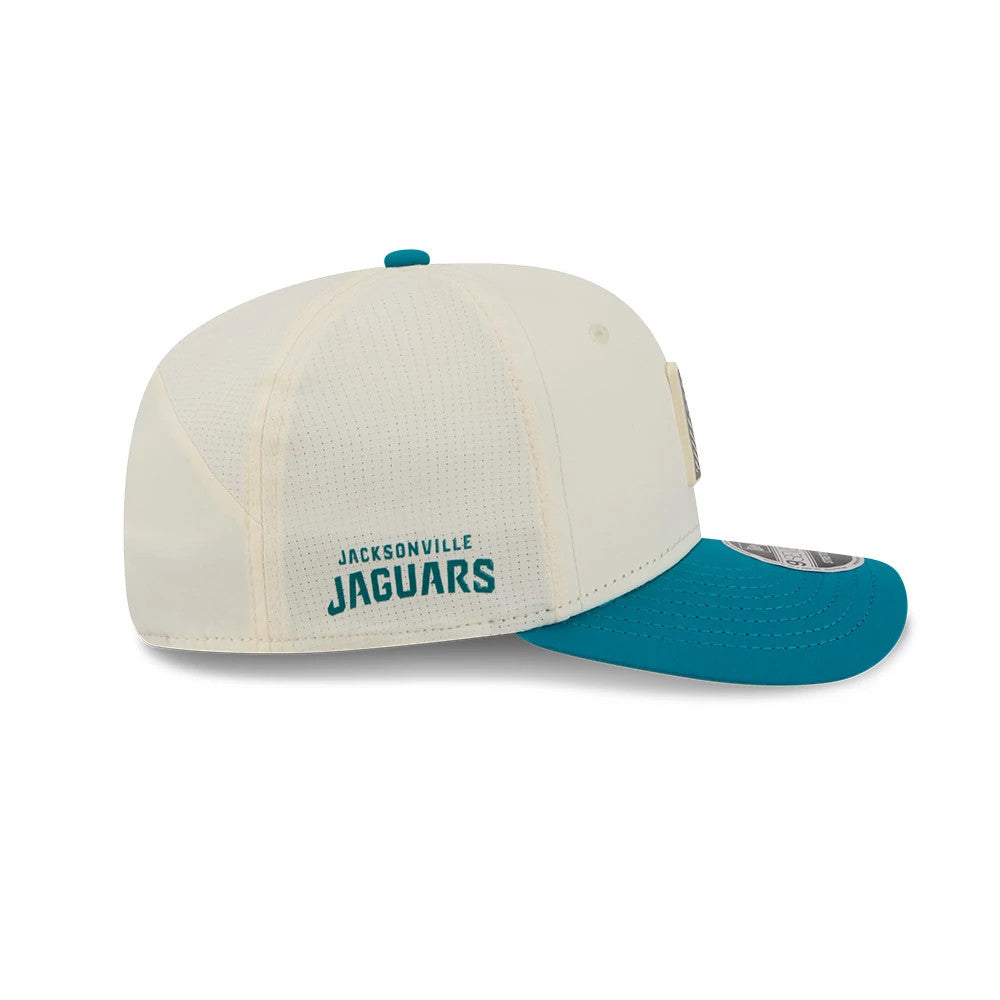 Jaguars NFL Training 2026 White New Era 9SEVENTY Stretch Snap Adjustable Cap, side view showing the teal embroidered Jacksonville Jaguars logo on the cream mesh back panels, teal curved visor and the New Era flag logo on the left side.