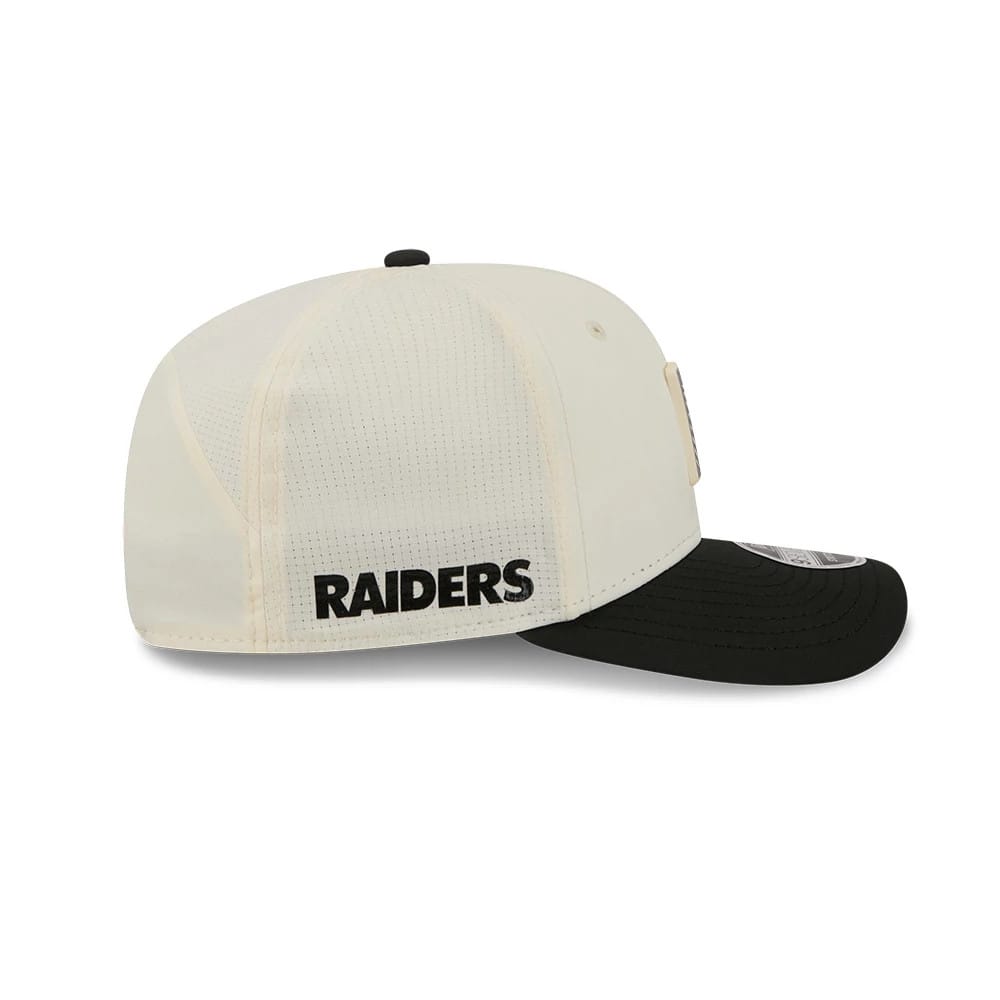 Raiders NFL Training 2026 White New Era 9SEVENTY Stretch Snap Adjustable Cap, side view showing the black embroidered Raiders logo on the white crown, with a black curved visor and 9SEVENTY size sticker.