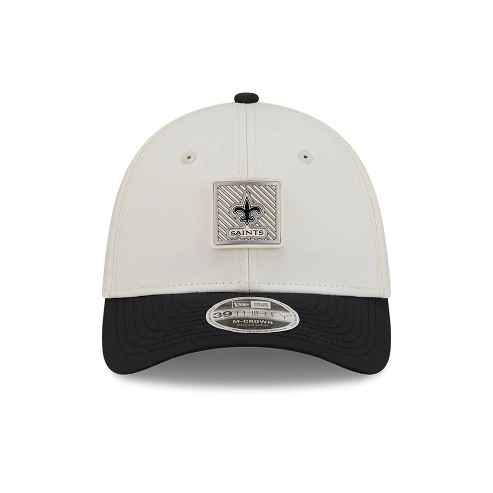 New Orleans Saints NFL Training 2026 White New Era 39THIRTY M-Crown Stretch Fit Cap, front view with a square emblem showcasing the Saints logo on the structured white crown, black curved visor, and 39THIRTY size sticker on the visor.