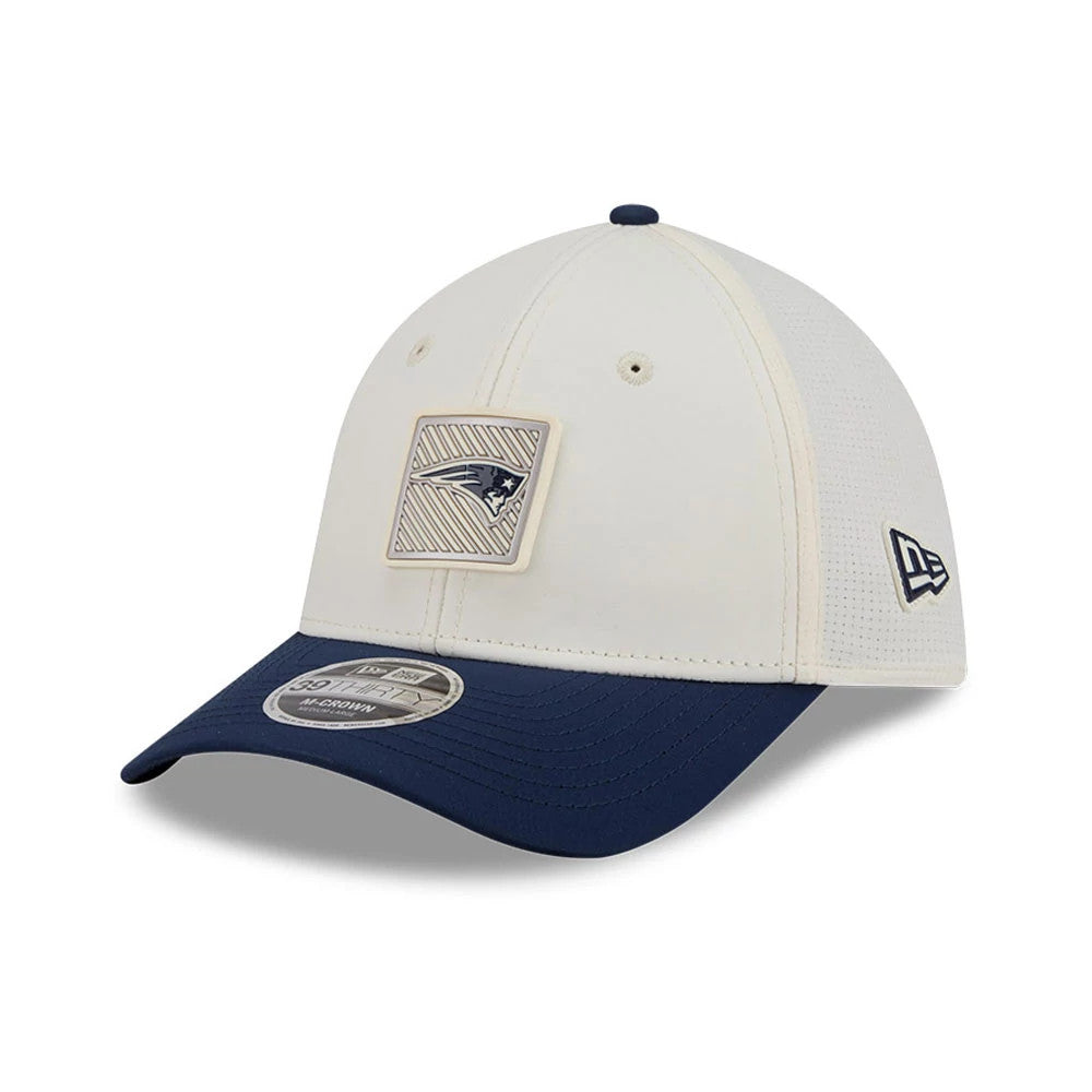 Patriots NFL Training 2026 White New Era 39THIRTY M-Crown Stretch Fit Cap, three-quarter view showing a textured Patriots badge on the white front panel, a blue curved visor with a 39THIRTY size sticker, and the New Era flag logo on the left side.