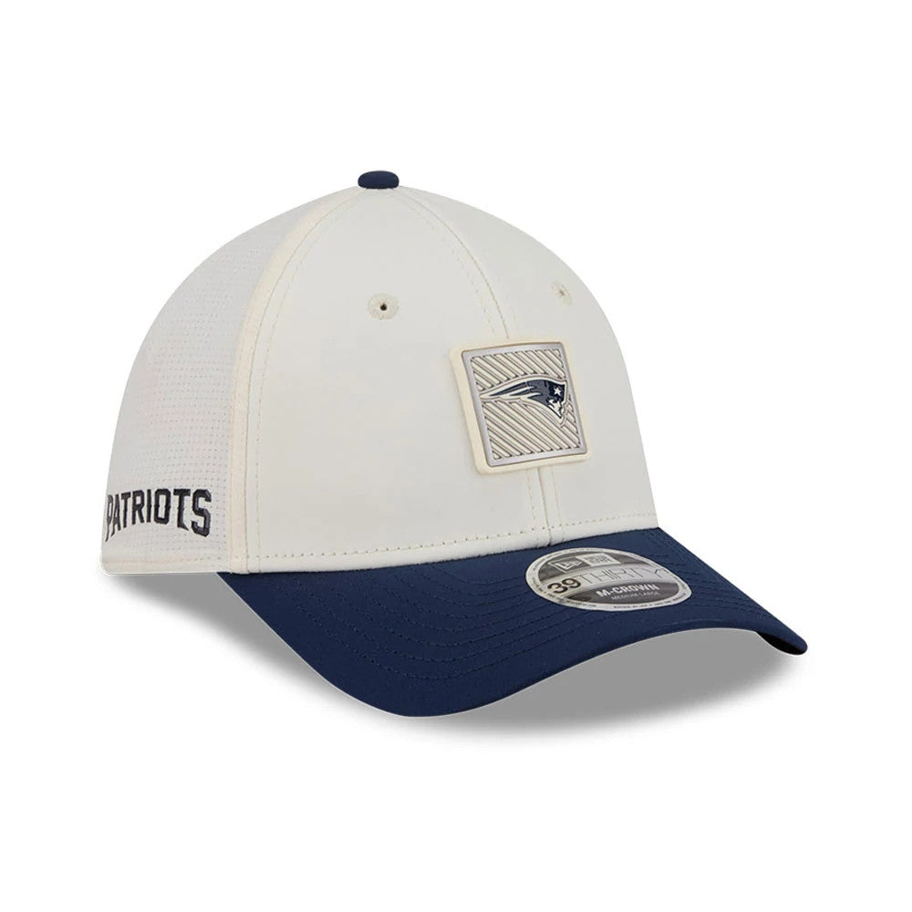 Patriots NFL Training 2026 White New Era 39THIRTY M-Crown Stretch Fit Cap, three-quarter view showing the raised embroidered team logo on the front white panel, navy curved visor with a 39THIRTY size sticker, and Patriots lettering on the left side.