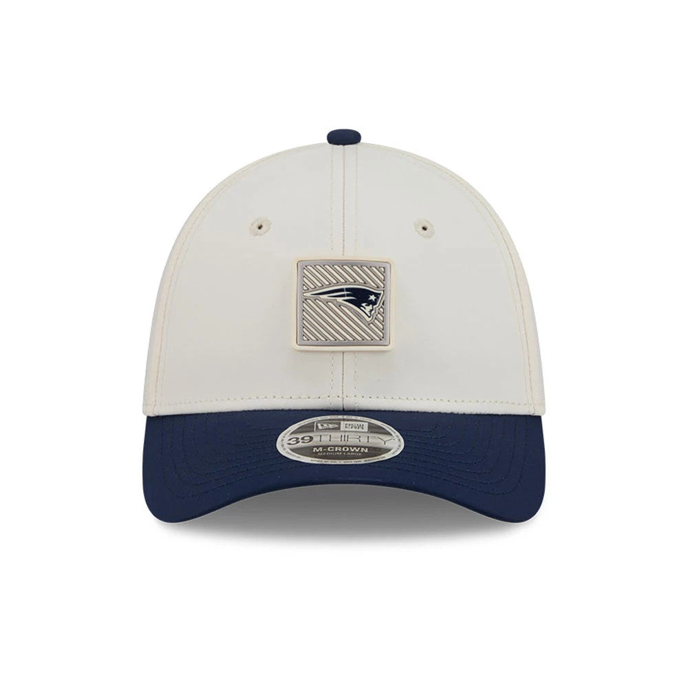 Patriots NFL Training 2026 White New Era 39THIRTY M-Crown Stretch Fit Cap, front view showing a large Patriots logo patch on the centre of the white crown, navy blue curved visor, and 39THIRTY size sticker on the visor.