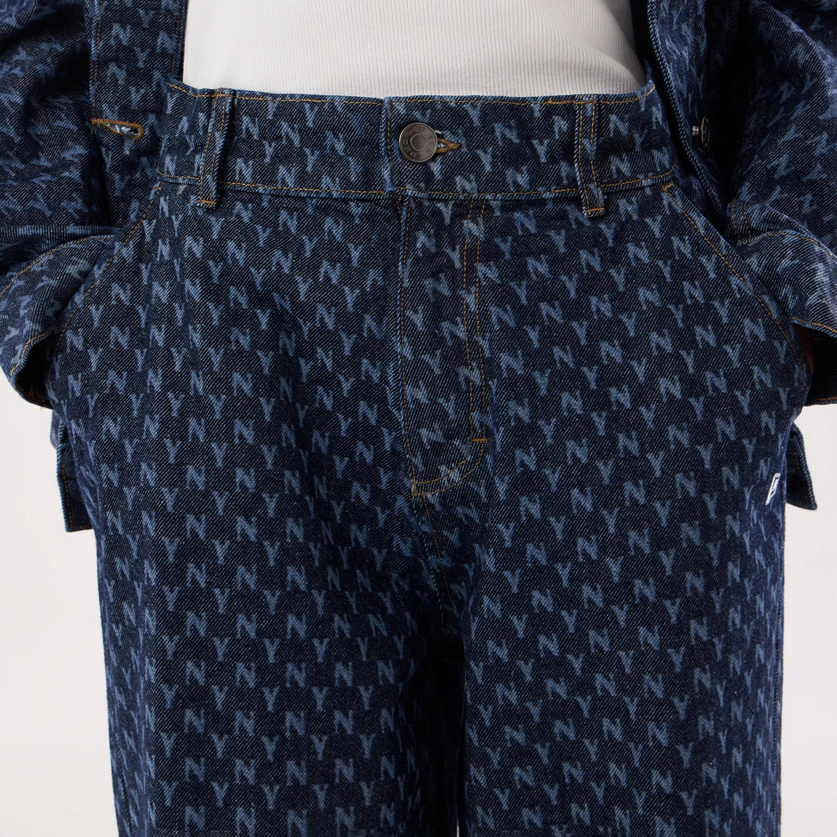 New Era New York Yankees Womens MLB Denim Navy Wide Leg Trousers, front view showing an all-over NY pattern in a lighter blue on denim, with a button and zip fastening, belt loops, and stitching around the pockets and seams.