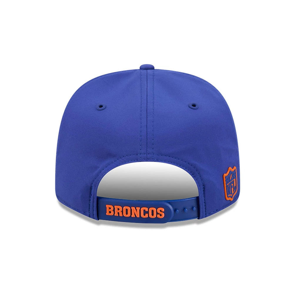 Broncos NFL Sideline 2026 Blue New Era 9SEVENTY Stretch Snap Adjustable Cap, rear view showing the orange BRONCOS lettering on the blue snapback closure, with an embroidered NFL logo shield patch on the right side and matching blue eyelets.