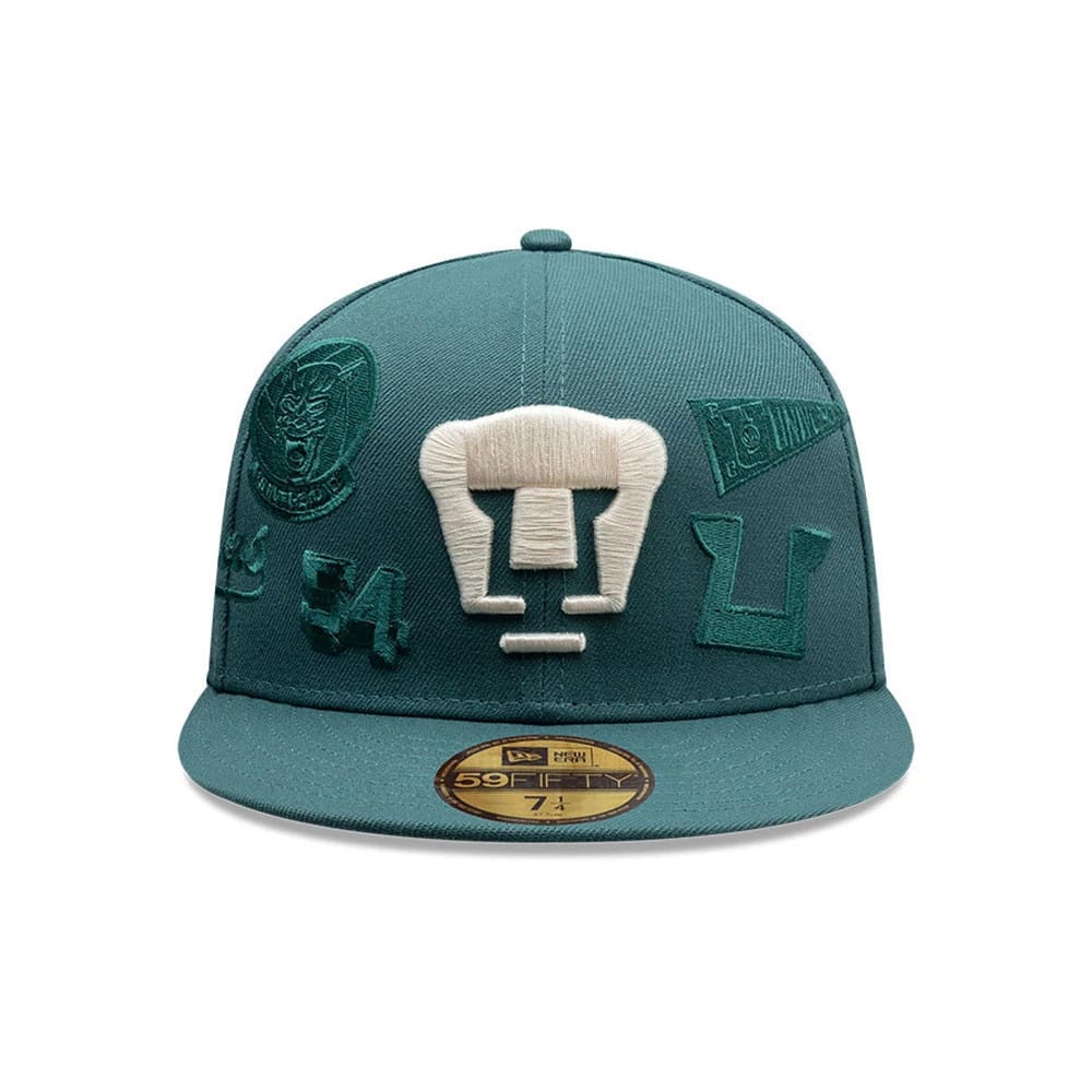 Pumas Unam Liga MX All Over Dark Green New Era 59FIFTY Fitted Cap, front view showing a large white embroidered Pumas logo on the structured green crown, various dark green embroidered team graphics, and a gold 59FIFTY size sticker on the flat visor.