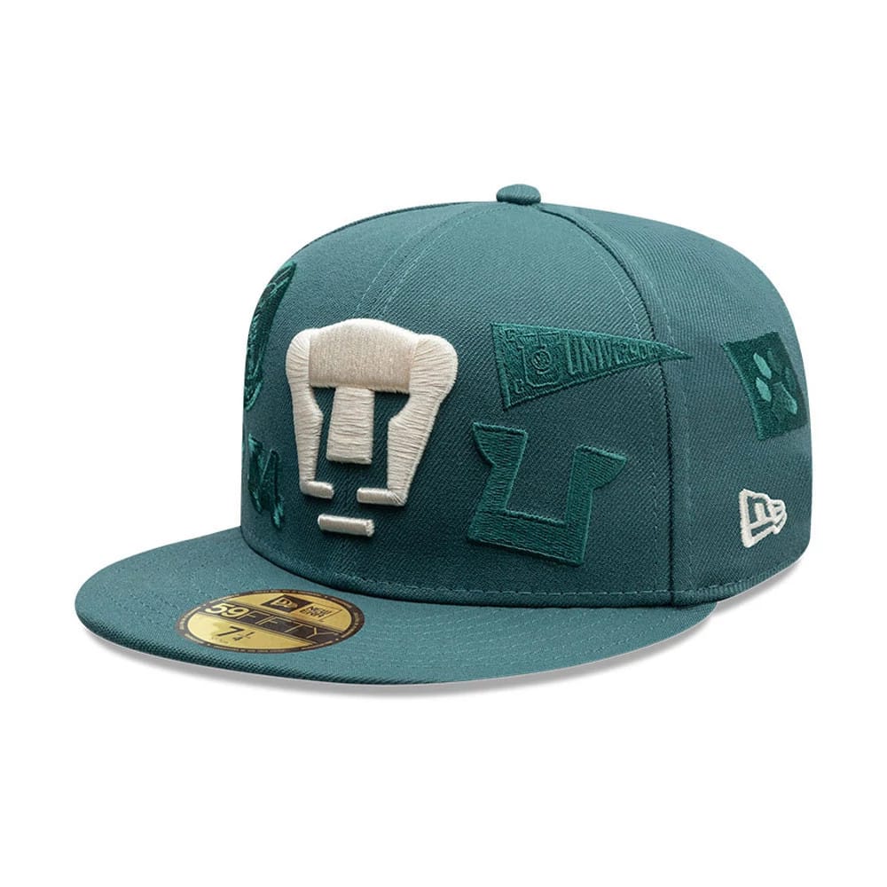 Pumas Unam Liga MX All Over Dark Green New Era 59FIFTY Fitted Cap, three-quarter view showing large beige embroidered Pumas logo on the front panel, various dark green patches across the crown, and New Era flag logo on the left side.