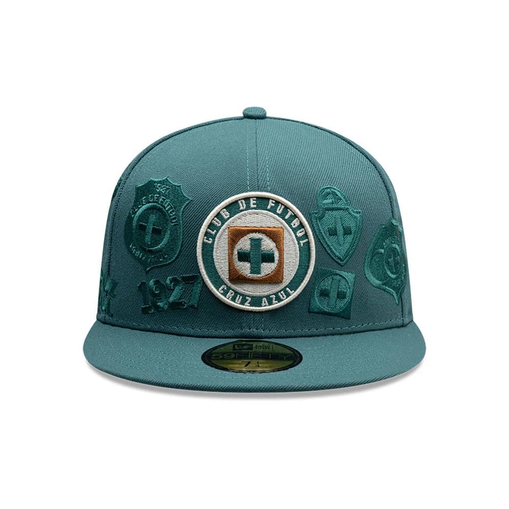 Cruz Azul Liga MX All Over Dark Green New Era 59FIFTY Fitted Cap, front view showing a central embroidered Cruz Azul logo on the front panel, surrounded by various dark green club patches, with a flat visor and a gold 59FIFTY size sticker.