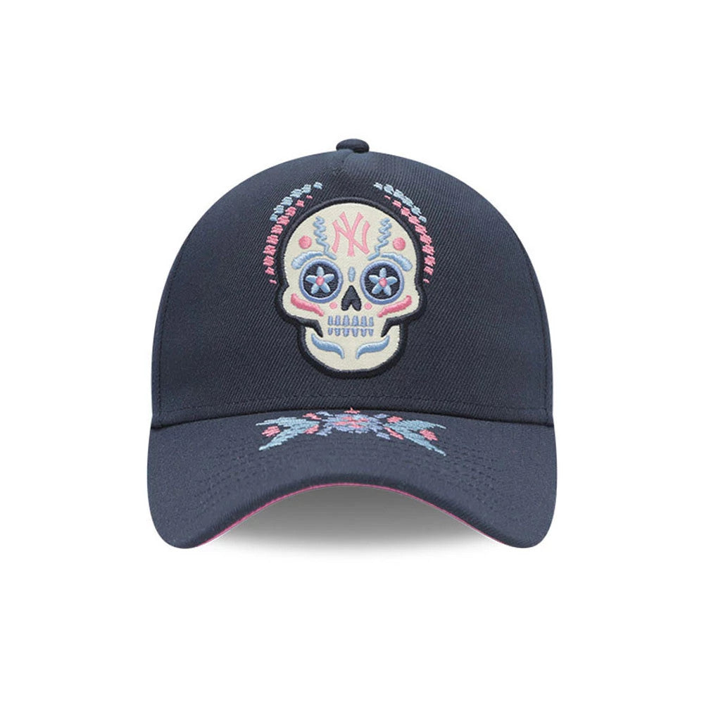 Yankees MLB Day Of The Dead Dark Blue New Era 9FORTY A-Frame Adjustable Cap, front view showing a multicoloured embroidered sugar skull design with a pink and light blue pattern, set above on the dark blue curved visor.