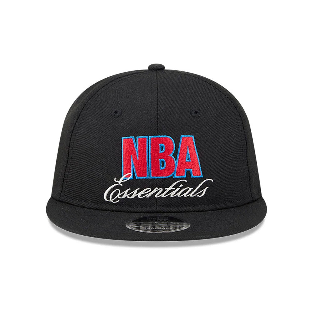FOG x NBA Logo Black Retro Crown New Era 9FIFTY Snapback Adjustable Cap, front view showing the raised red and blue NBA Essentials embroidery on the black front panel, with a curved black visor and a 9FIFTY size sticker on its visor.