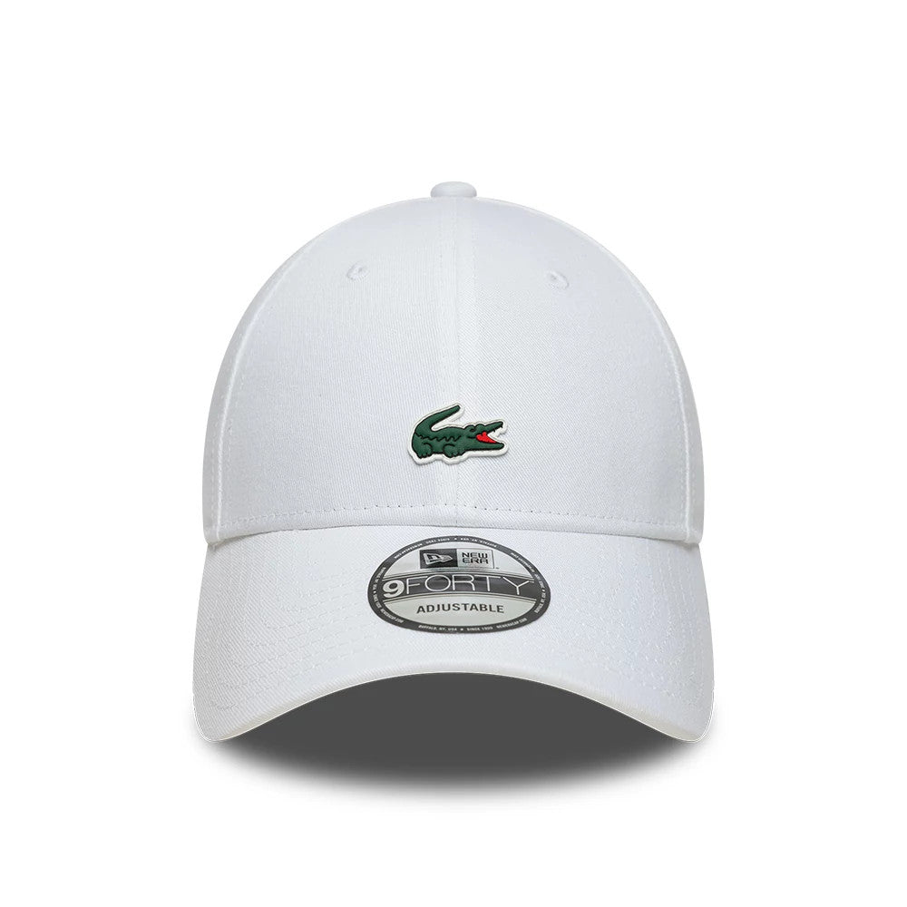 Lacoste X New Era White 9FORTY Adjustable Cap, front view showing a green embroidered Lacoste crocodile logo on the front panel, a curved white visor with a 9FORTY size sticker, and a matching white top button.