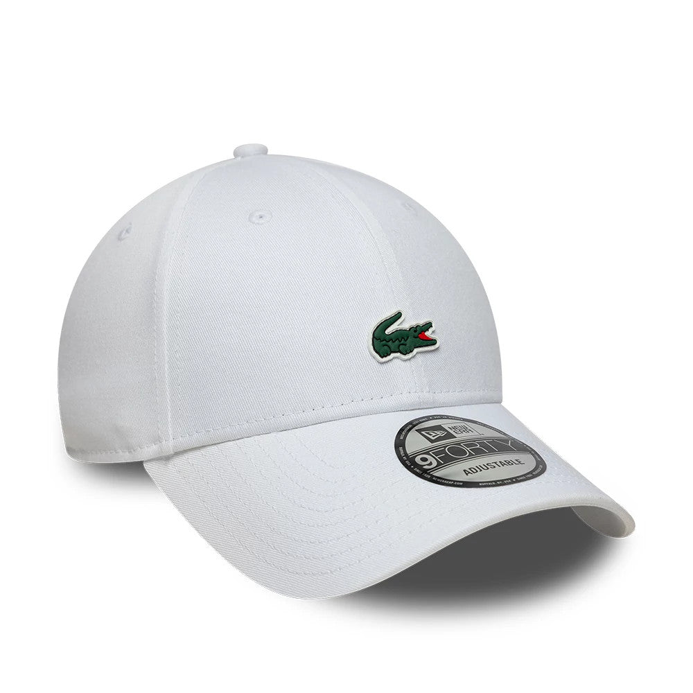 Lacoste X New Era White 9FORTY Adjustable Cap, front view showing the raised green Lacoste crocodile logo embroidered on the front panel, a curved white visor, and a 9FORTY size sticker on the visor's surface.