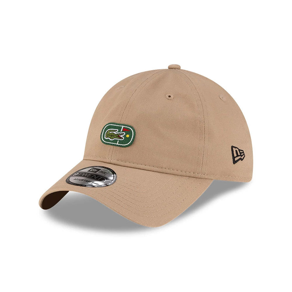 Lacoste X New Era Beige 9TWENTY Adjustable Cap, three-quarter view showing the green Lacoste crocodile logo on the front panel, black embroidered New Era flag logo on the left side, and the silver 9TWENTY size sticker on the curved visor.