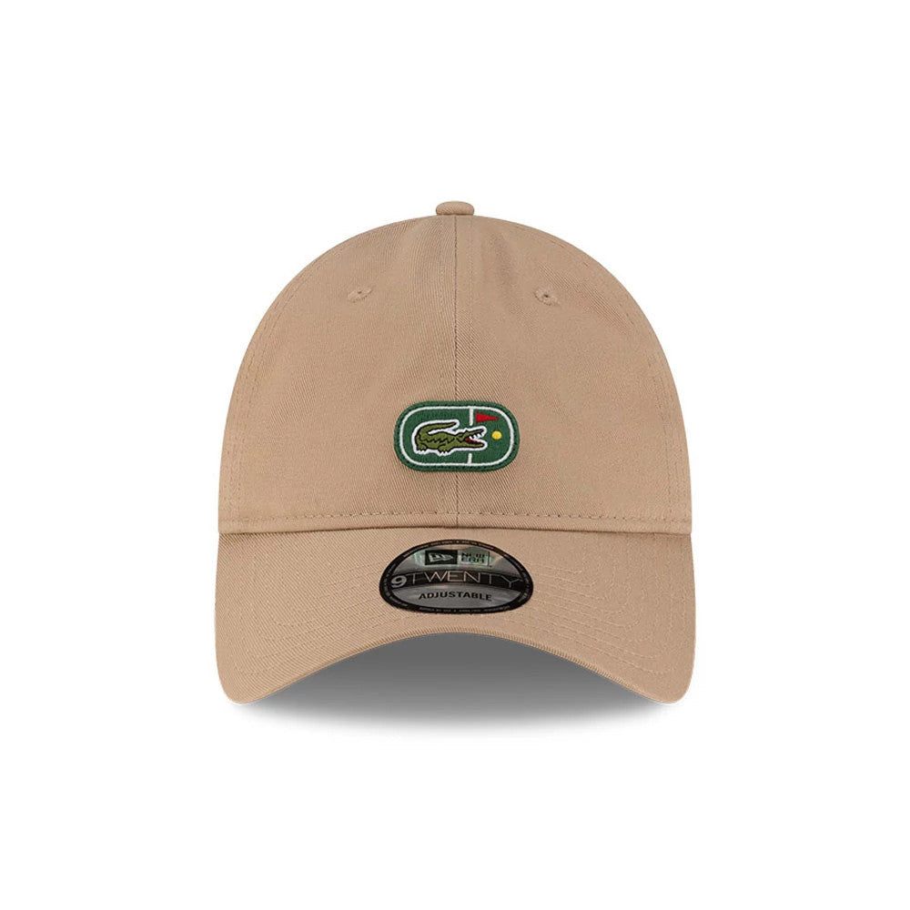 Lacoste X New Era Beige 9TWENTY Adjustable Cap, front view showing the green and white Lacoste embroidered logo on the centre of the crown, with a curved beige visor and a 9TWENTY size sticker on the visor.
