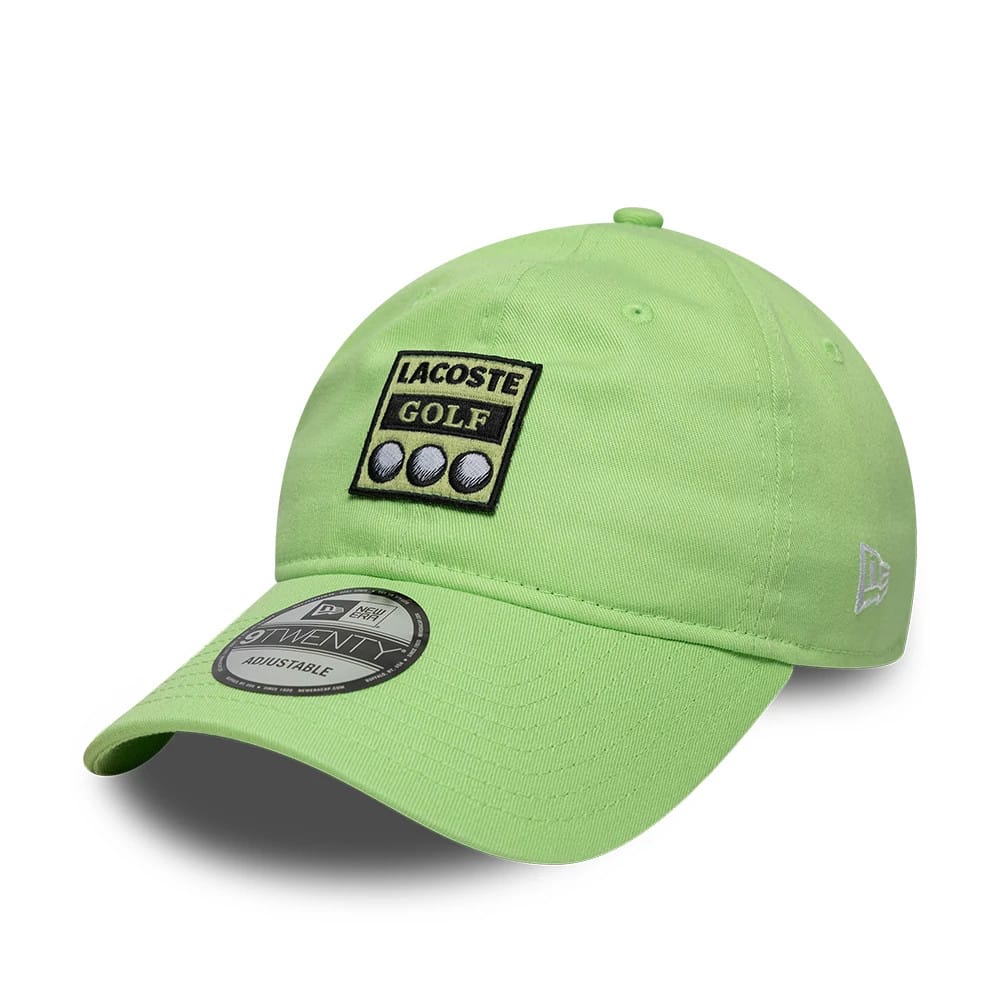 Lacoste X New Era Pastel Green New Era 9TWENTY Adjustable Cap, three-quarter view showing the Lacoste Golf patch with three golf ball motifs on the front panel, the curved visor with a 9TWENTY size sticker.