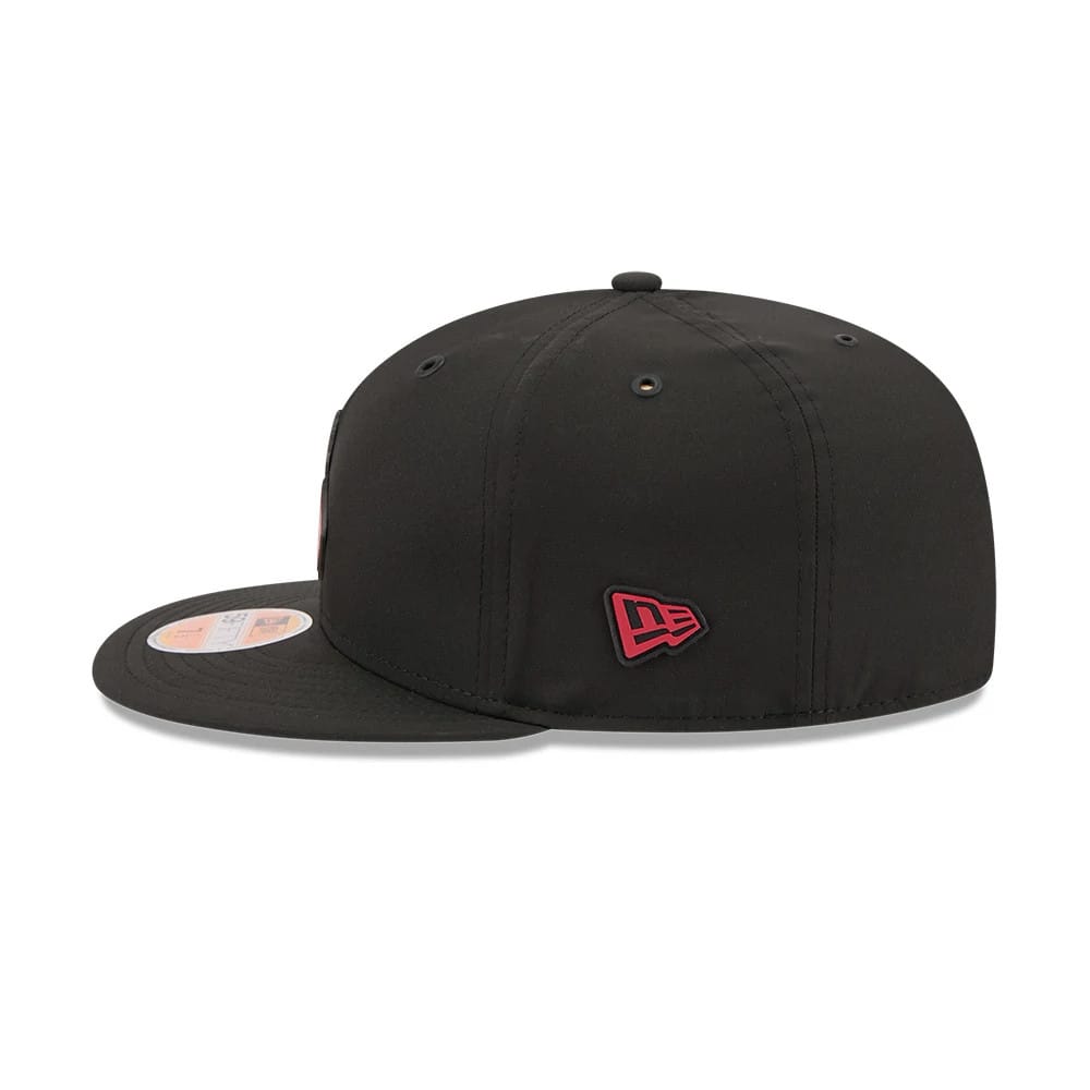 Arizona Cardinals NFL Sideline 2026 Black New Era 59FIFTY Fitted Cap, side view showing the red embroidered New Era flag logo on the left side, with a structured black crown, black flat visor, and 59FIFTY size sticker on the visor.