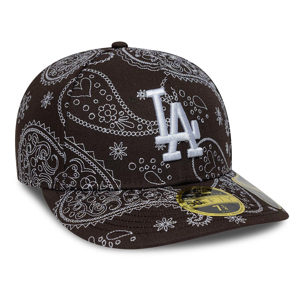 LA Dodgers MLB All Over Paisley Dark Brown New Era Low Profile 59FIFTY Fitted Cap, front view showing the white embroidered LA logo on the structured dark brown crown, intricate white paisley design, and a gold 59FIFTY size sticker on the visor.