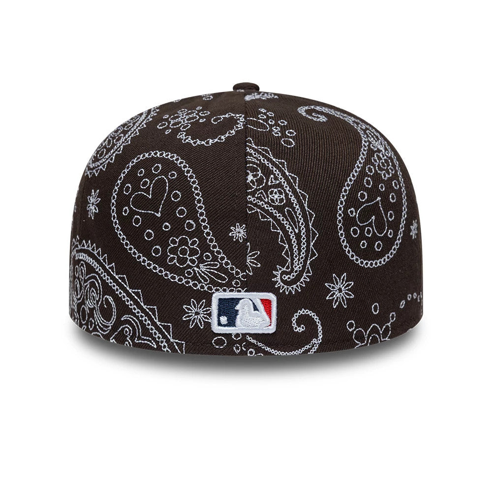 LA Dodgers MLB All Over Paisley Dark Brown New Era Low Profile 59FIFTY Fitted Cap, rear view showing the white embroidered MLB Batterman logo at the centre of the back panels, with intricate white paisley patterns on the dark brown fabric.