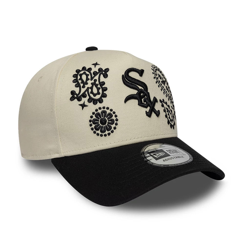 Chicago White Sox MLB Paisley Cream & Black New Era 9FORTY E-Frame Adjustable Cap, three-quarter view showing black raised embroidery of the team's logo on the cream front panel, with additional paisley patterns and a black curved visor.