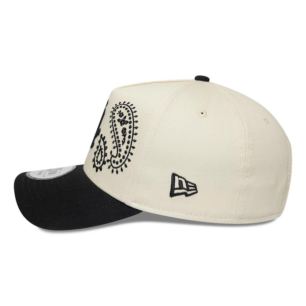 Chicago White Sox MLB Paisley Cream & Black New Era 9FORTY E-Frame Adjustable Cap, side view showing the intricate black paisley embroidery on the cream front panels and the embroidered New Era flag logo on the left side, with a curved black visor.