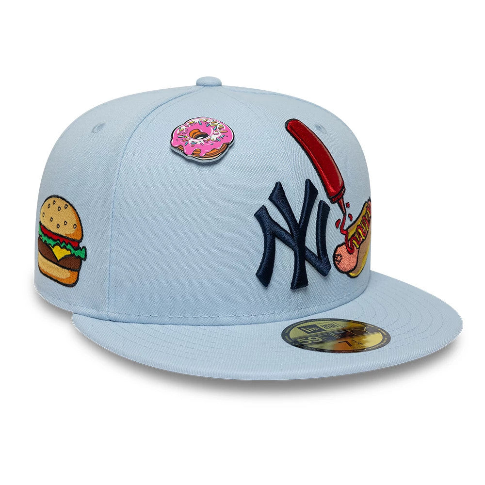 New York Yankees MLB Food Pastel Blue New Era 59FIFTY Fitted Cap, front view showing raised navy NY logo embroidered on the light blue crown, colourful embroidered food graphics including a donut and hotdog.