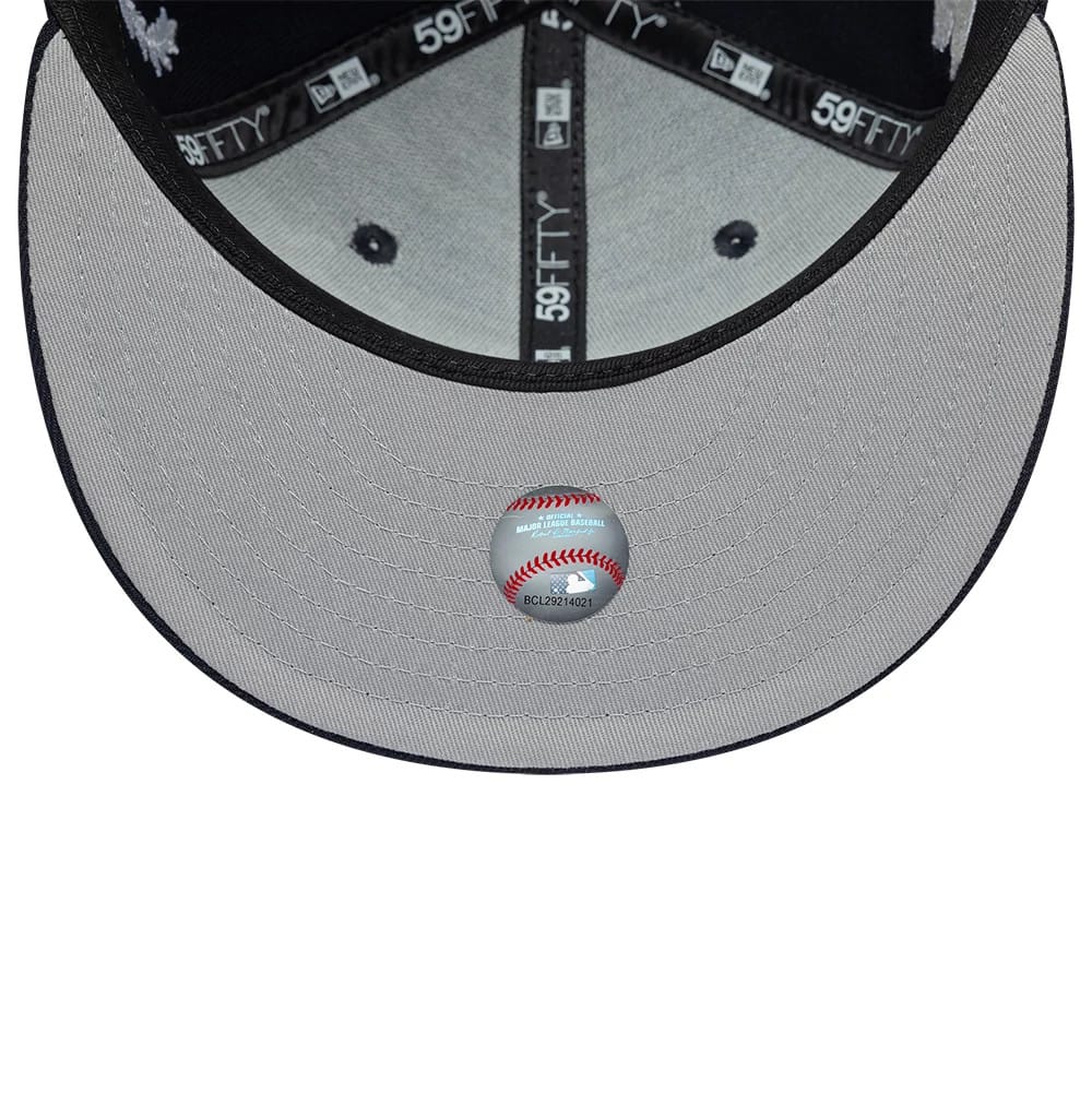 New York Yankees MLB Mythical Navy New Era 59FIFTY Fitted Cap, inside view showing the grey undervisor with an MLB baseball sticker, black taping with 59FIFTY branding, and black sweatband lining the cap's interior.