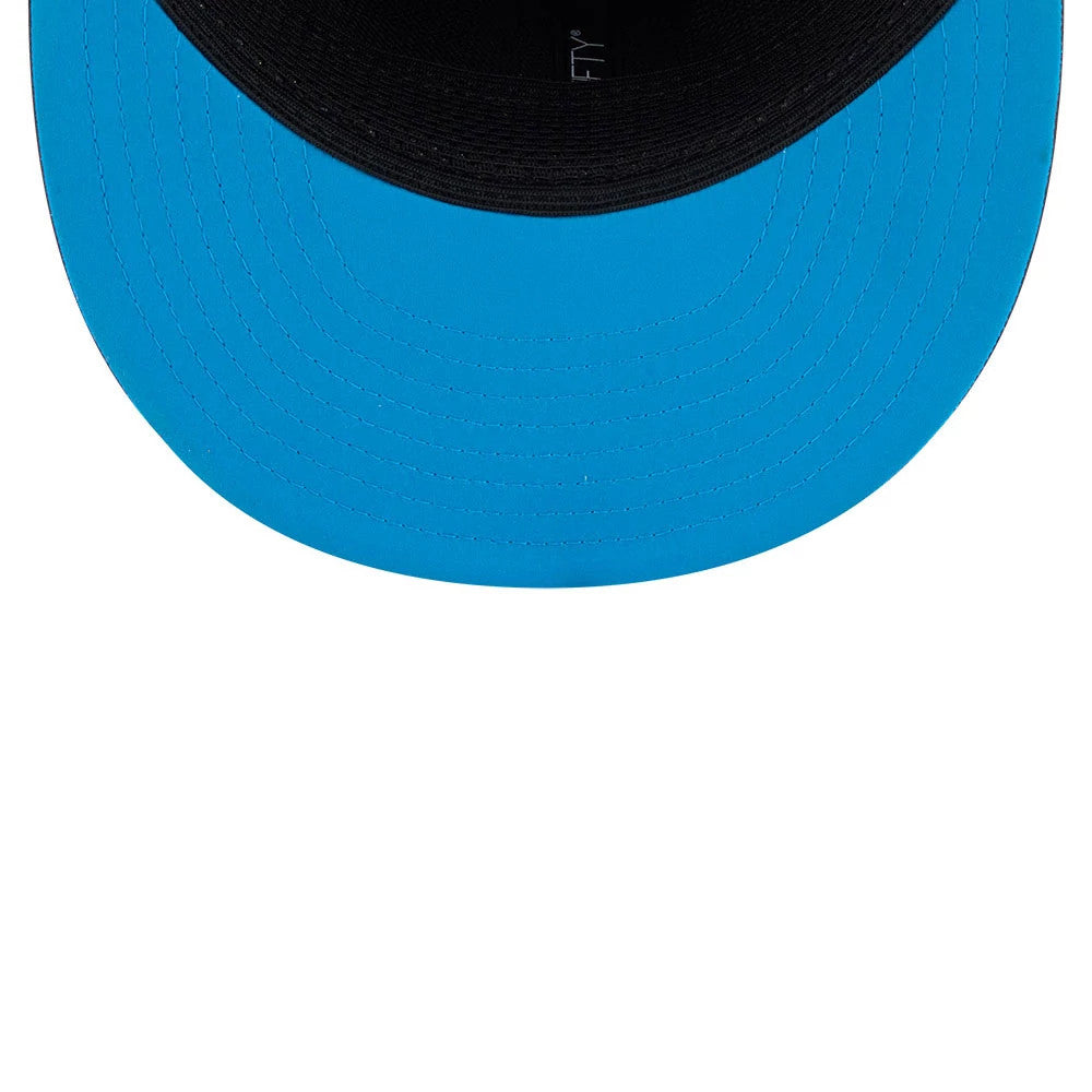 Panthers NFL Sideline 2026 Charcoal New Era 9FIFTY Snapback Adjustable Cap, inside view showing a bright blue undervisor, black sweatband, and black internal taping with the 9FIFTY logo printed in white, creating a contrast.