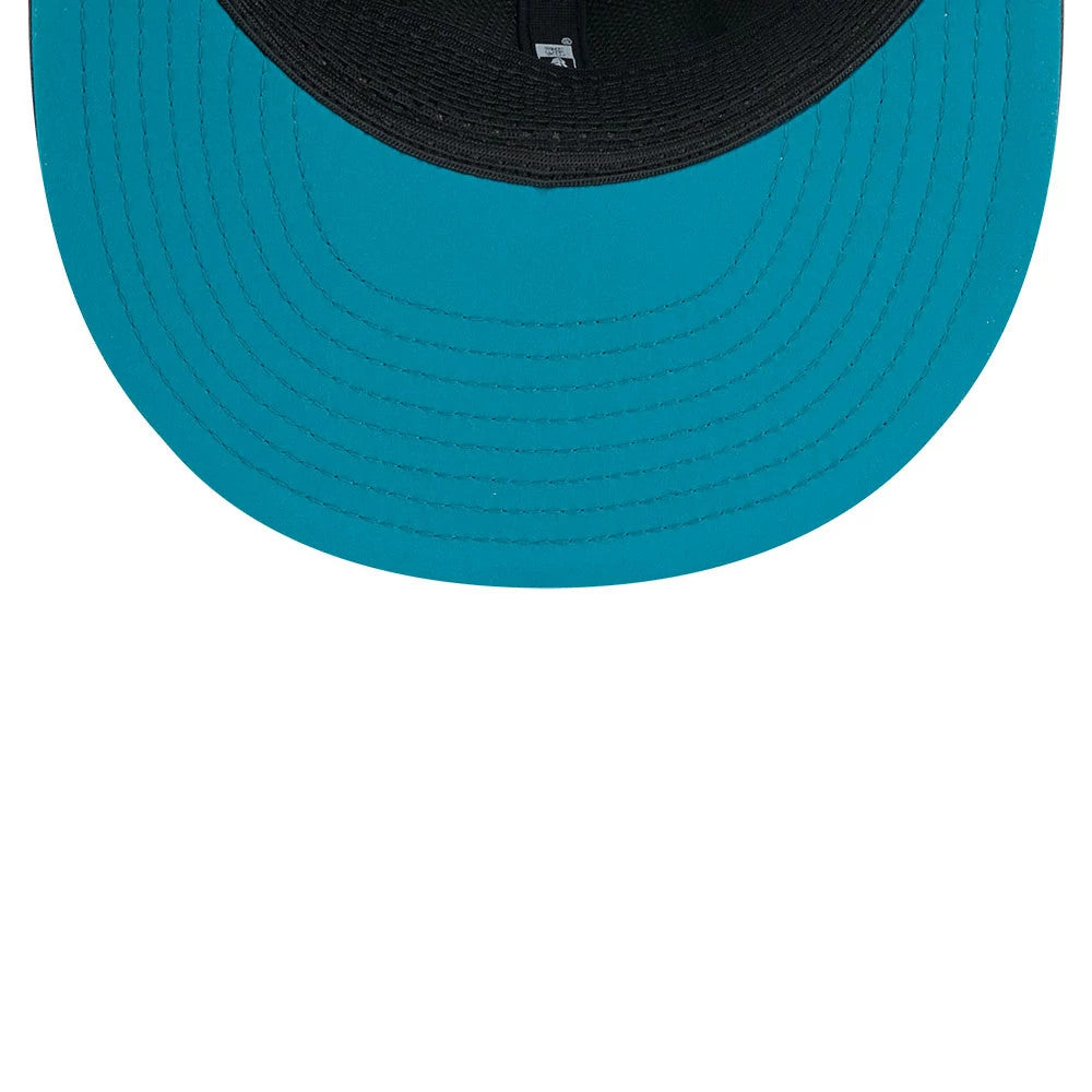 Jaguars NFL Sideline 2026 Charcoal New Era 9FIFTY Snapback Adjustable Cap, inside view showing the teal undervisor, black sweatband, and branded taping along the seams, with a snap closure partially for adjustable sizing.