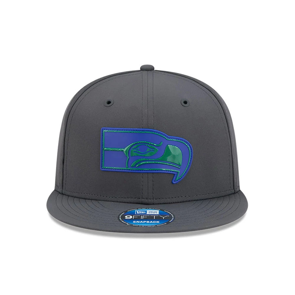 Seahawks NFL Sideline 2026 Charcoal New Era 9FIFTY Snapback Adjustable Cap, front view showing a raised blue and green Seahawk logo embroidered on the front panel, a flat charcoal visor, and a 9FIFTY size sticker on the visor.