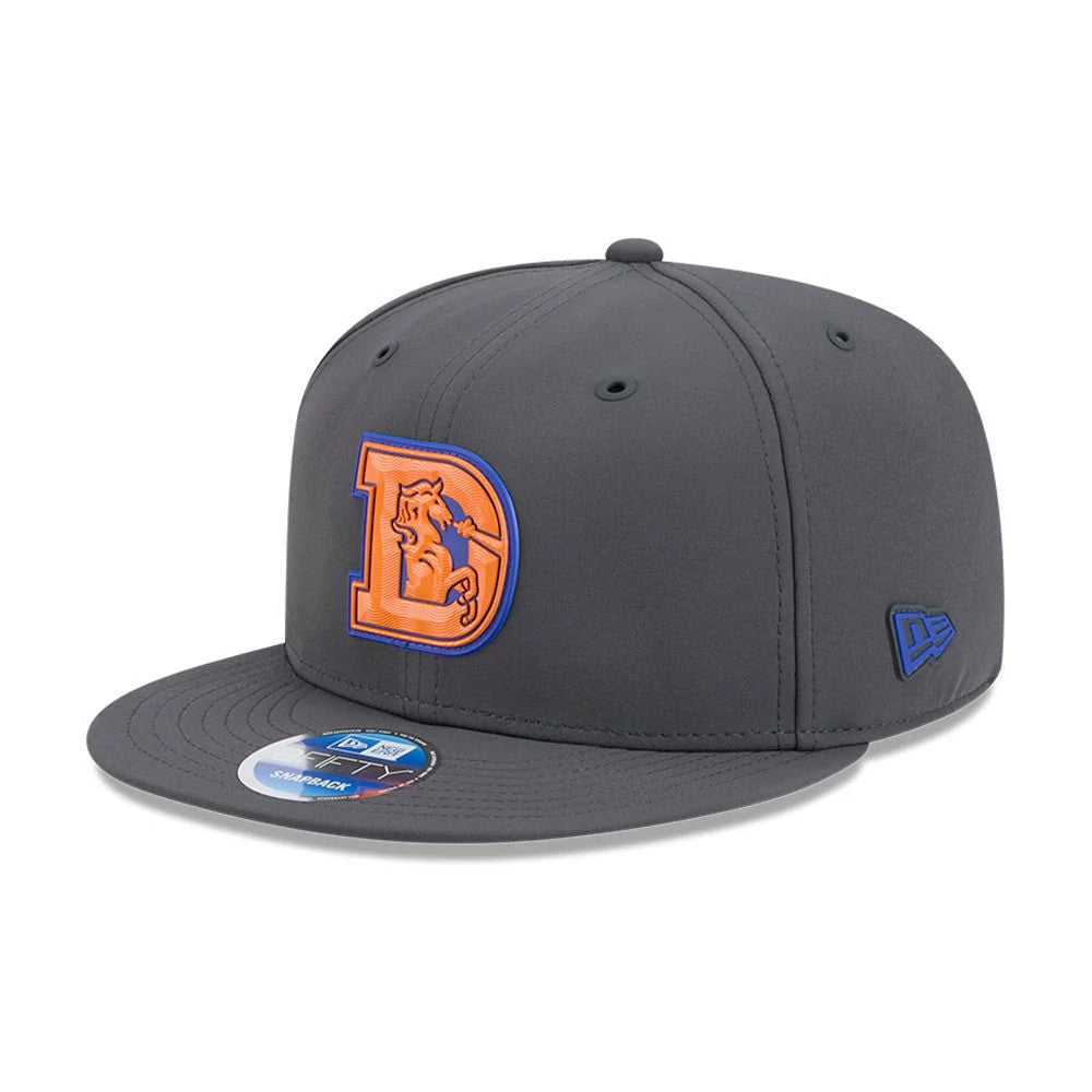 Denver Broncos NFL Sideline 2026 Charcoal New Era 9FIFTY Snapback Adjustable Cap, front view showing a raised orange and blue embroidered D logo on the front panel, with a matching flat charcoal visor and a 9FIFTY size sticker.