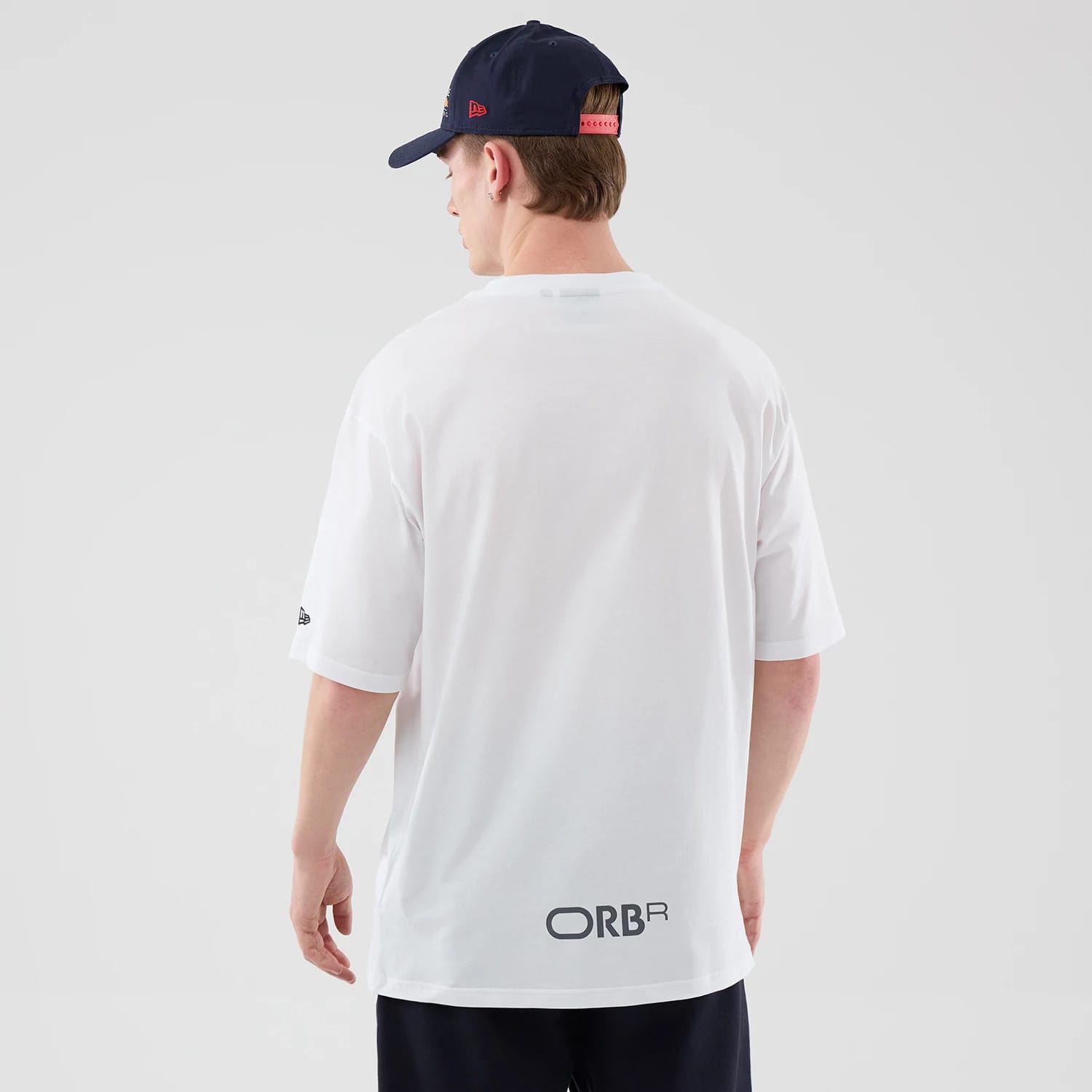The model is wearing this Red Bull Racing Graphic Oversized T-Shirt in white. 2