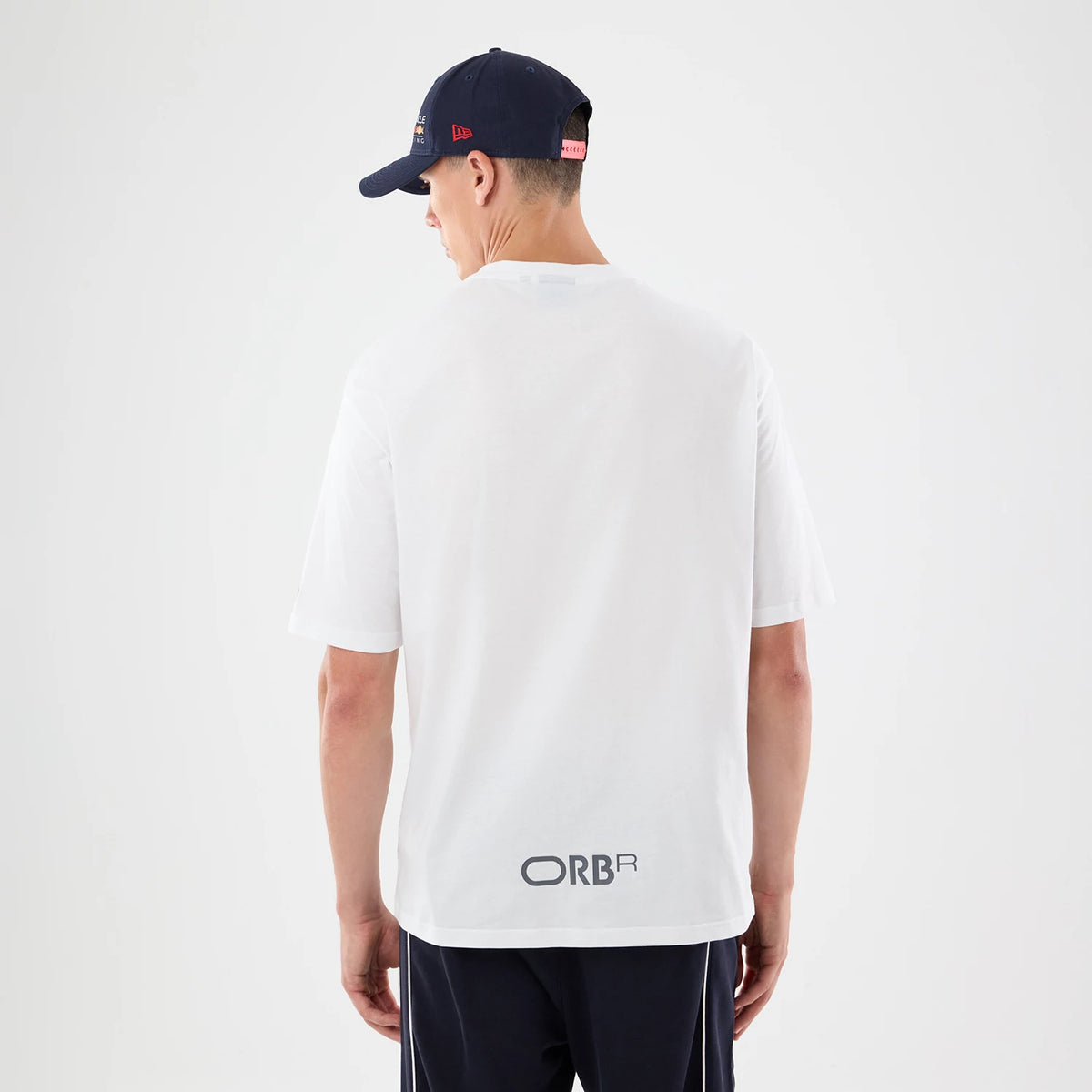The model is wearing this Red Bull Racing Graphic Oversized T-Shirt in white. 2
