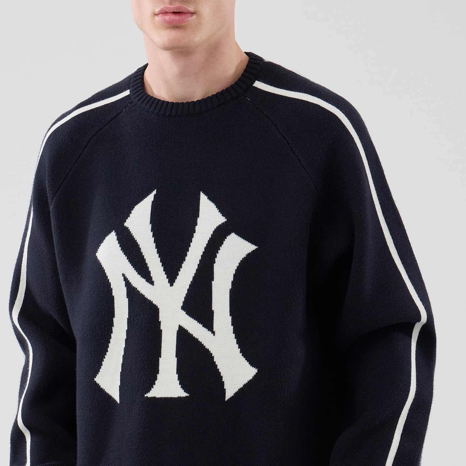The model is wearing this MLB Knit New York Yankees Knitted Sweater in navy. 3