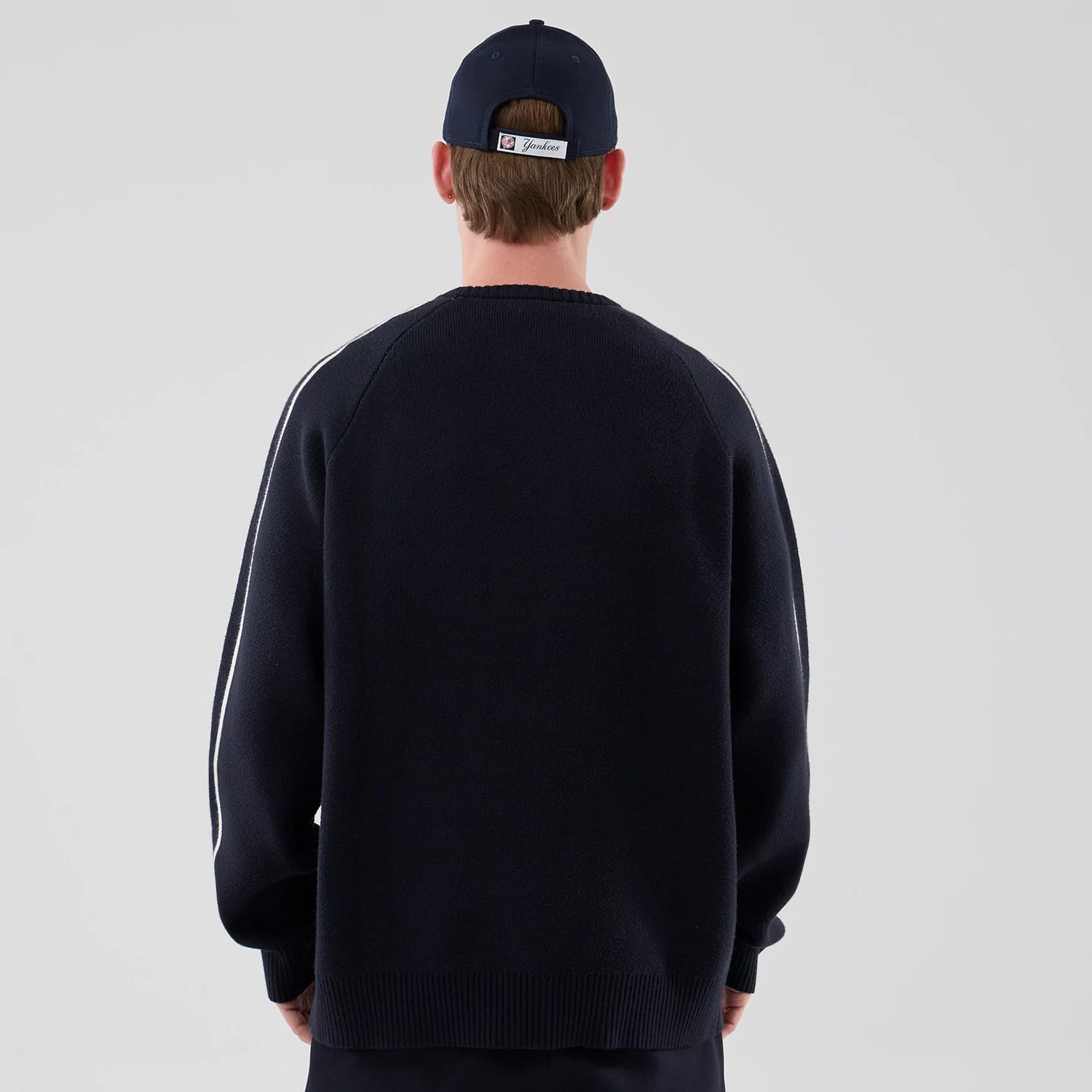 The model is wearing this MLB Knit New York Yankees Knitted Sweater in navy. 2