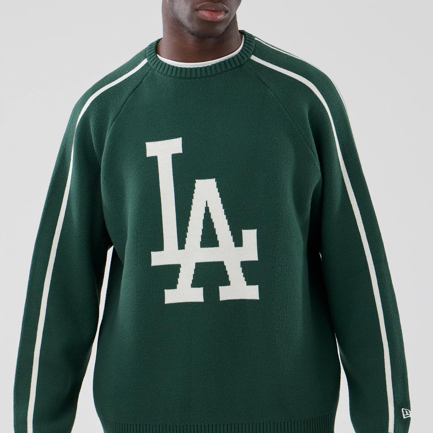 The model is wearing this MLB Knit LA Dodgers Knitted Sweater in dark green. 3